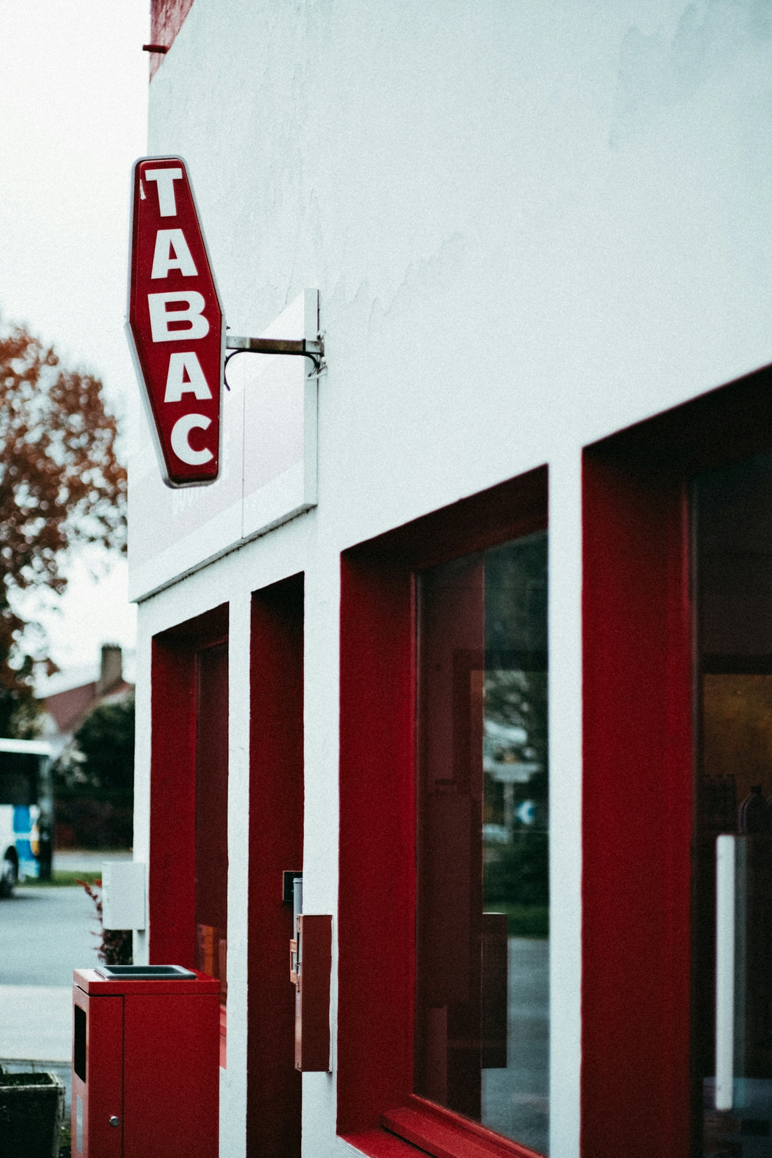 a red and white building with a sign on the side of it