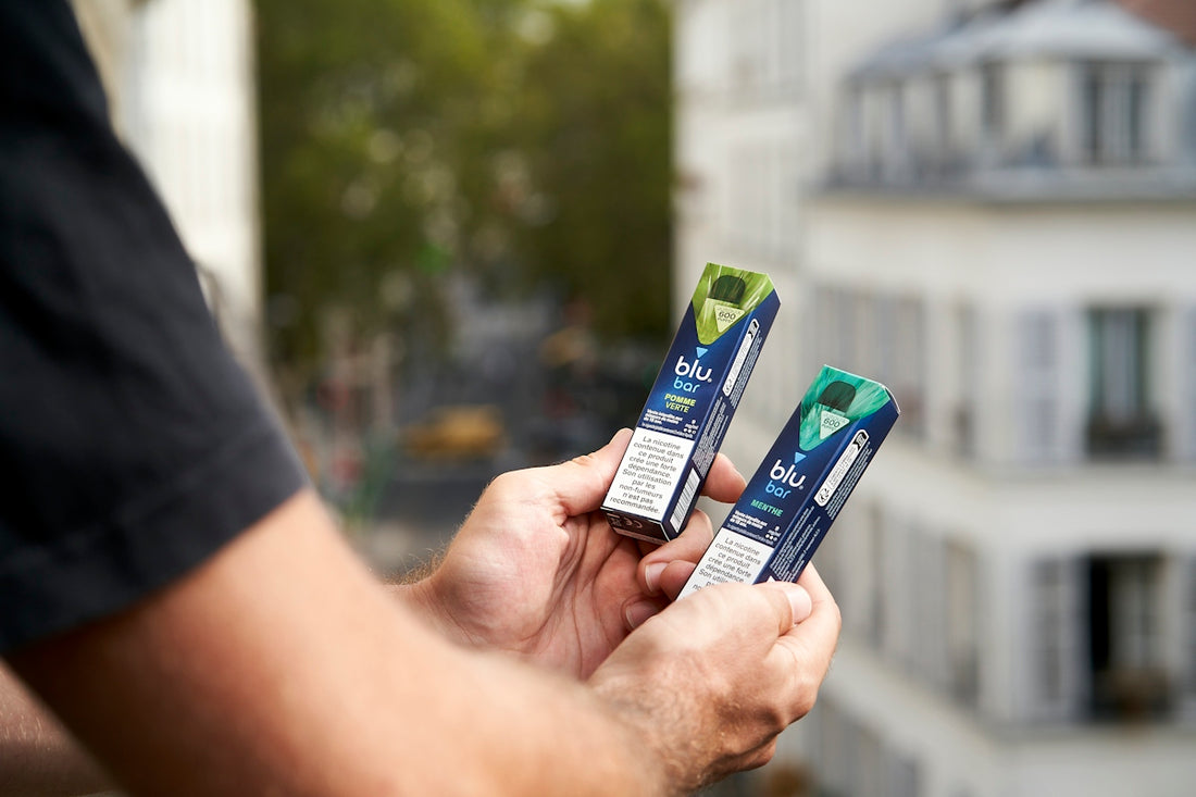A person holding three toothbrushes in their hands