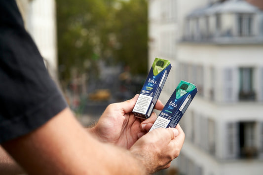 A person holding three toothbrushes in their hands
